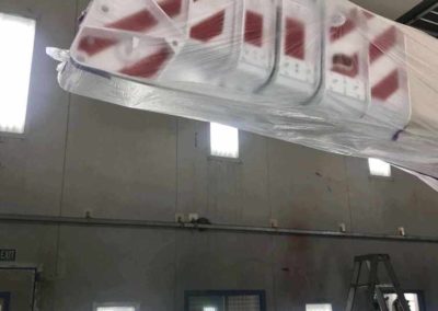 This photo of a crane boom demonstrates the height available in Simpson Crash's big spray painting booths